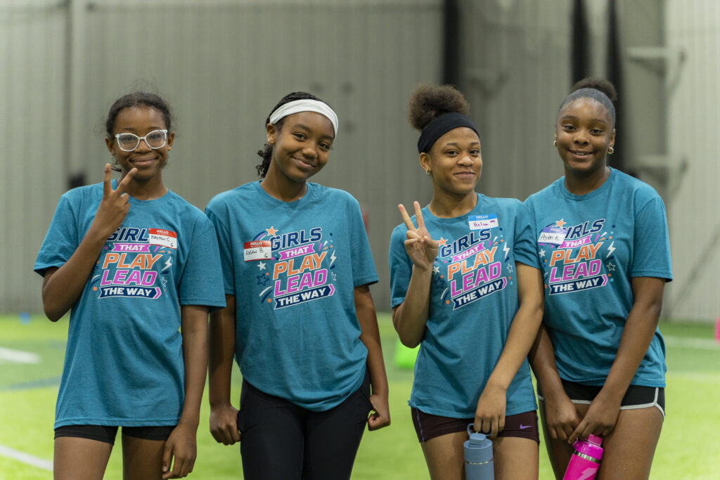 Group of youth smiling and posing for picture.